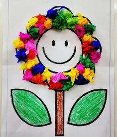 a paper plate with a flower on it and a smiley face drawn in the middle