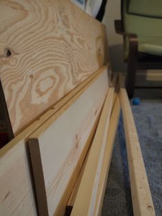 a wooden bench sitting on top of a carpeted floor