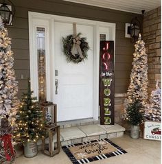 front porch decorated with christmas trees and wreaths