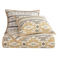 two pillows on top of each other with an orange and white pattern in the middle