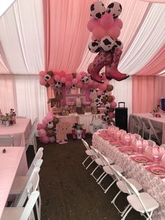 a pink and white decorated party with balloons