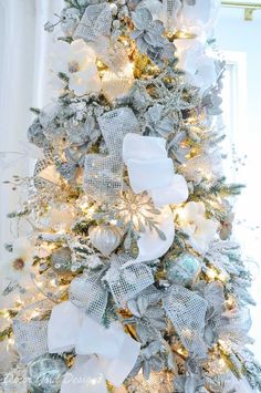 a christmas tree decorated with silver and white ornaments