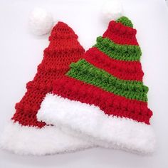 two knitted christmas hats sitting on top of each other