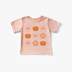 Pumpkins and Flowers Pumpkins and Flowers Tee Features & Sizing *Crewneck, pullover styling *Short sleeves *Print as shown Materials & Care *Soft Feel * 100 % Cotton - White, Pink, Natural *50% polyester, 25% combed & ringspun cotton, and 25% rayon - Peach *Machine wash cold, dry flat *Iron inside out Toddler Thanksgiving Shirt, Pumpkins And Flowers, Peach Shorts, Halloween Adventure, Summer Graphic Tee, Daisy Girl, Toddler Fall, Hello Pumpkin, Thanksgiving Shirt