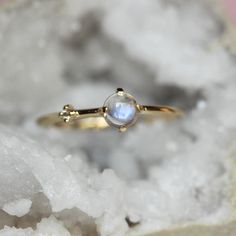 Every hero needs a sidekick...With our "Sidekick" ring in 14K gold, you can feel super all the time! Center moonstone is accented on one side by a tiny diamond. Super cute! - 4mm smooth moonstone - 1.3mm diamond - 1.3mm round band - Available in solid 10K or 14K gold For our amethyst "Sidekick" ring click here: https://www.etsy.com/listing/580095152/14k-amethyst-diamond-ring-sidekick-ring?ref=shop_home_active_23 Processing times -  Current processing time is 1 - 3 weeks. Each Item is handmade to Asymmetrical Ring, Moonstone Rings, Pretty Engagement Rings, Ring Inspo, Ring Moonstone, Amethyst And Diamond Ring, Zierlicher Ring, Cabochon Ring, Tiny Diamond