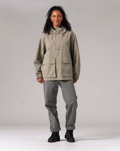 The Takibi Ripstop Anorak is a durable, fire-resistant hooded jacket. The anorak features two large flap pockets on the front, drawcords at the hood and hem, a covered half zipper on the front, and a zipper on the left side for easy on and off. Additional features include hand warmer pockets, an accessory loop on the right breast, ventilated panels on the back, and elastic cuffs. The material is an aramid-cotton blend with ripstop stitching throughout for fire resistance and durability. Hand Warmers, Flap Pocket, Hooded Jacket, Stitching, Cotton Blend, Elastic, Zipper, Cross Stitching