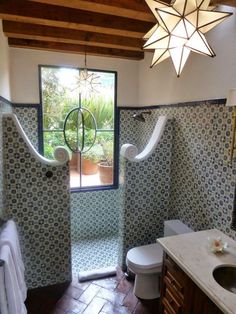 a bathroom with blue and white tiles on the walls