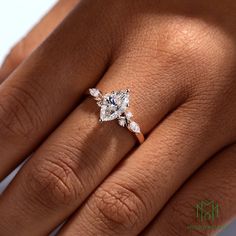 a woman's hand with a diamond ring on it