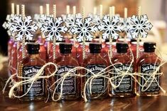 several bottles of hot sauce on a table with snowflakes in the top one