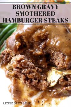 brown gravy smothered hamburger steaks on a white plate with green beans