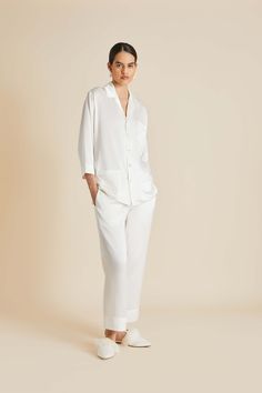 The Fifi Ivory Pearl pyjama is what sweet dreams are made of. Ensure a blissful sleep the night before your wedding (and every night thereafter) with this signature set, cut from the finest ivory silk satin and finished with real pearl buttons. Pair with the Audrey Ivory Pearl eye mask for a match made in heaven. Material: 100% silk Material Weight: 19 momme Material Weave: satin Colour: ivory Trims: flat silk piping, real pearl buttons Product Code: BR002 White Silk Pajamas, White Bridal Robe, Cashmere Robe, Adult Onesie Pajamas, Bubu Gown Styles, China Clothes, Luxury Sleepwear, Olivia Von Halle, Family Pajama Sets