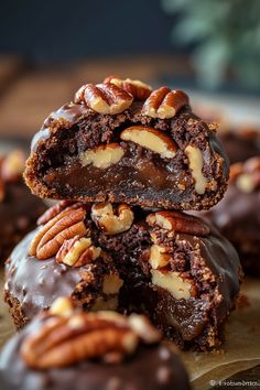 chocolate covered cookies with pecans and nuts stacked on top of each other, ready to be eaten