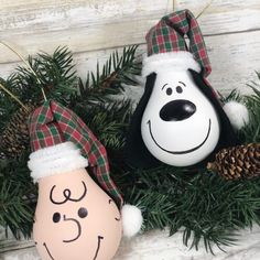 two ornaments are hanging on a christmas tree