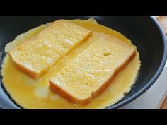 two pieces of bread are being cooked in a skillet