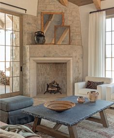 a living room filled with furniture and a fire place