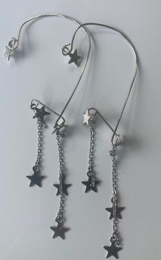 earwrap, 2 dangle, silver stars on chain. Sold Singly, for a pair order 2. Star Shaped Earrings With Adjustable Chain For Gifts, Star-shaped Metal Jewelry With Adjustable Chain, Sterling Silver Star Charm Drop Earrings, Star-shaped Earrings With Adjustable Chain As Gift, Star-shaped Metal Earrings With Dangling Charms, May 2024, Silver Stars, Favorite Jewelry, Jewelry Earrings Dangle