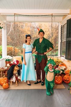 a man and woman in costumes standing on porch