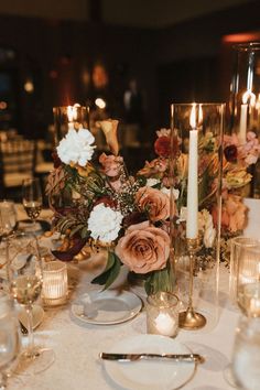 the table is set with candles and flowers