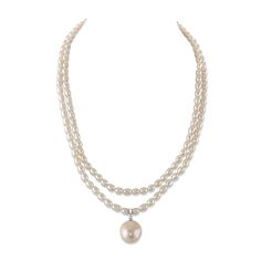 This 4.5-5.0mm oval white freshwater double strand pearl necklace is certain to grab the attention of anyone who sees this beauty. This pearl necklace is compiled of two strands of hand picked oval white freshwater pearls with high grade luster that has an exquisite 14-16mm dangling baroque pearl dangling. This necklace feature a 17" extendable to 18" Sterling silver or Yellow gold plated clasp. White Double Strand Pearl Necklace With Pearl Drop, White Double Strand Pearl Drop Necklace, Elegant Double Strand Pearl Necklace With Charm, Double Strand Pearl White Necklace With Pearl Pendant, Double Strand Pearl Pendant Necklace In White, Pearl White Oval Beads Pearl Necklace, Double Strand Akoya Pearl Necklace, Elegant Double Strand Pearl Necklace With Pendant, White Oval Pearl Necklace