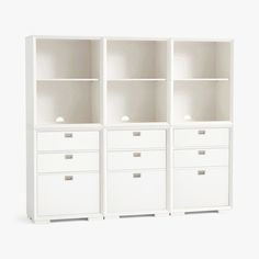 three white bookcases with drawers on each side