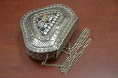 It is an elegantly crafted evening purse. It is made out of metal brass. It has a beautiful shell pattern throughout the purse. Nice additional for any outfit. The size is 7 1/2" length x 6" width x 2" thickness. Silver Metal Evening Bag As Gift, Silver Metal Clutch As Gift, Traditional Handmade Silver Evening Bag, Gold Bohemian Clutch For Formal Events, Bohemian Gold Clutch For Formal Occasions, Vintage Silver Clutch As Gift, Rectangular Metal Evening Bag Gift, Rectangular Metal Evening Bag For Gifts, Vintage Silver Clutch As A Gift