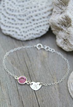 This listing is for one bracelet, made especially for a little girl! Personalized sterling silver chain bracelet with one sweet initial heart tag and one Swarovski Birthstone charm. Please select initial and birthstone (or favourite color!) from the drop-down menus and indicate the size you need. The length/size includes the heart tag and birthstone charm. Half an inch of extension chain is always added - for better fit and easy adjustment as the child grows. The bracelet size recommendations ar Embossed Jewelry, Girl Bracelet, Heart Tag, Personalized Bracelet, Girl Jewelry, Silver Heart Necklace, Silver Chain Bracelet, Bracelet Sterling Silver, Personalized Bracelets