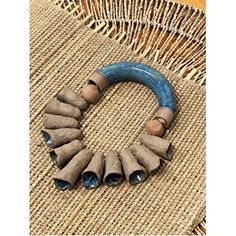 a blue and brown bracelet on top of a woven chair