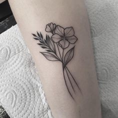 a black and white flower tattoo on the leg