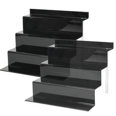 four black acrylic shelves stacked on top of each other in the shape of a pyramid