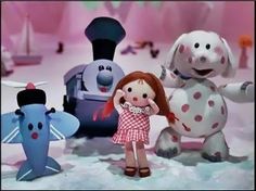 there is a girl standing in front of three cartoon characters, one with red hair and the other with blue eyes