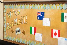 a bulletin board with flags and words on it