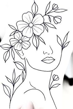 a woman's face with flowers in her hair, drawn on paper by hand