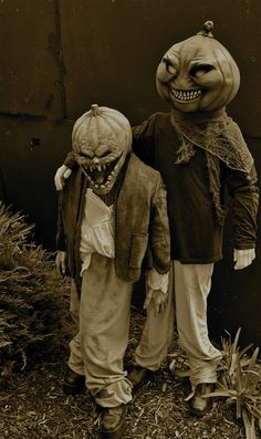 two children dressed in halloween costumes standing next to each other