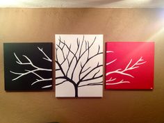 three paintings are hanging on the wall next to each other, one has a tree painted on it