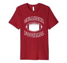 a red t - shirt with the words oklahoma football printed on it and an image of a football