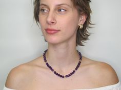 This richly colored amethyst bead necklace features gorgeous 8.25mm round amethyst beads that have been hand strung with delicate white seed pearls and 18k yellow gold beaded spacers. This combination of royal purple, gold, and pearls allow this necklace to look casual or dressy, depending on what you choose to wear it with! Finished with a 14k yellow gold high-polished ball clasp, this is sure to be one of your new favorites!Necklace measures 16.5 inches in length Purple Round Bead Necklace For Formal Occasions, Elegant Single Strand Amethyst Beaded Necklace, Formal Purple Necklaces With Round Beads, Elegant Purple Round Beaded Necklaces, Formal Purple Beaded Necklaces, Purple Amethyst Pearl Necklace With Gemstone Beads, Purple Amethyst Gemstone Beads Pearl Necklace, Classic Purple Round Bead Jewelry, Elegant Purple Beaded Necklace With Round Beads