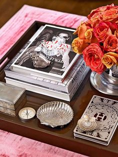 a tray with some books and flowers on it