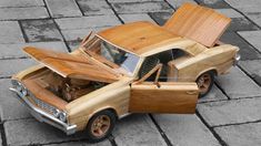 an old model car made out of wood