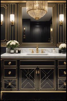 a bathroom with black walls, gold trim and marble countertops that has a chandelier over the sink