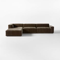 a large brown couch sitting on top of a white floor