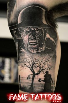 a man's arm with a tattoo on it that has an image of a demon and a tree