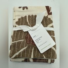 a folded piece of cloth with a tag on it's front and back side