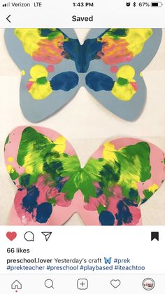 two butterfly shaped paper cut outs on top of each other