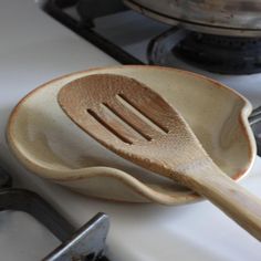 a wooden spatula sitting on top of a stove