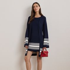 A navy-and-white two-tone design with a striped motif at the hem brings a nautical-inspired twist to this sweater dress while cap sleeves and a breezy shift silhouette make it the perfect style for transitional dressing.