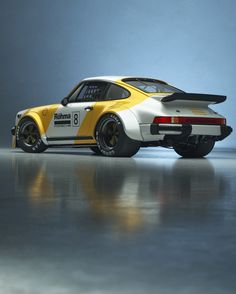 a yellow and white porsche sports car parked in a studio area with reflective flooring