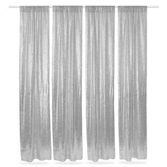 three silver curtains hanging on a white wall