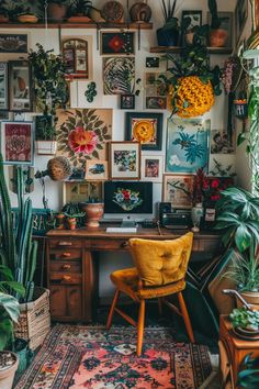 a home office with lots of plants and pictures on the wall, including a yellow chair