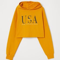 H&M Divided Mustard Usa San Francisco Pullover Crop Hoodie Size Small Brand: H&M Size: Small Item Is Brand New With Tags Attached. Usa San Francisco 1998 Graphic Hoodie Short, Lightweight Sweatshirt With A Printed Design. Hood With Wrapover Front, Heavily Dropped Shoulders, And Long Sleeves With Ribbed Cuffs. Roomy, Slightly Oversized Look. 100% Cotton Retail Price $24.95 Trendy Yellow Fall Sweatshirt, Trendy Yellow Sweatshirt For Fall, H&m Cotton Hoodie Sweatshirt, Casual Hooded Top By H&m, Casual Hooded Top From H&m, H&m Cotton Sweatshirt With Letter Print, Yellow Hoodie For Fall, Yellow Letter Print Sweatshirt For Fall, Yellow Hooded Top For Spring