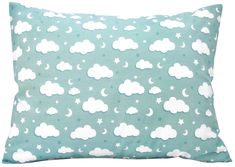 a blue pillow with white clouds and stars on it